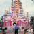 Designer/Art Director Mike Conrad standing in front of the completed Castle Cake